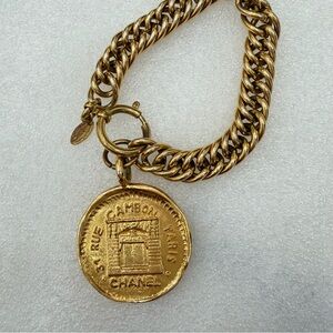 CHANEL Gold Chain Bracelet with large Medallion Charm.